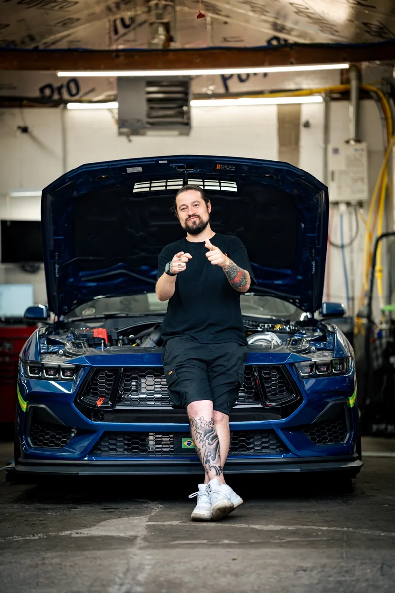 Dave, founder of Dave's Mechanic Shop, with a customer performance build