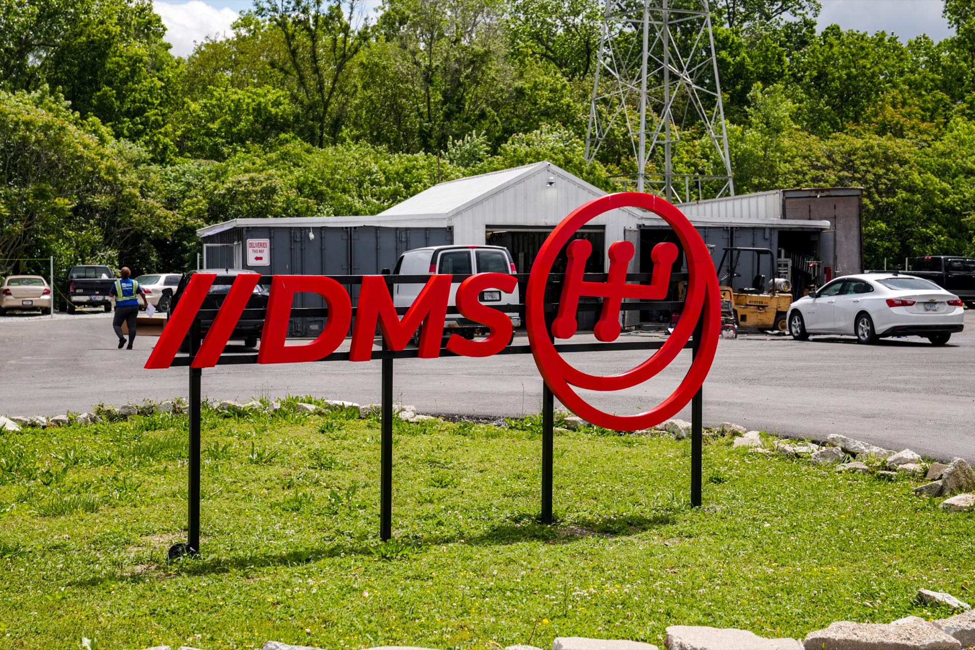 The red DMS sign in front of Dave's Mechanic Shop on South Tibbs Avenue