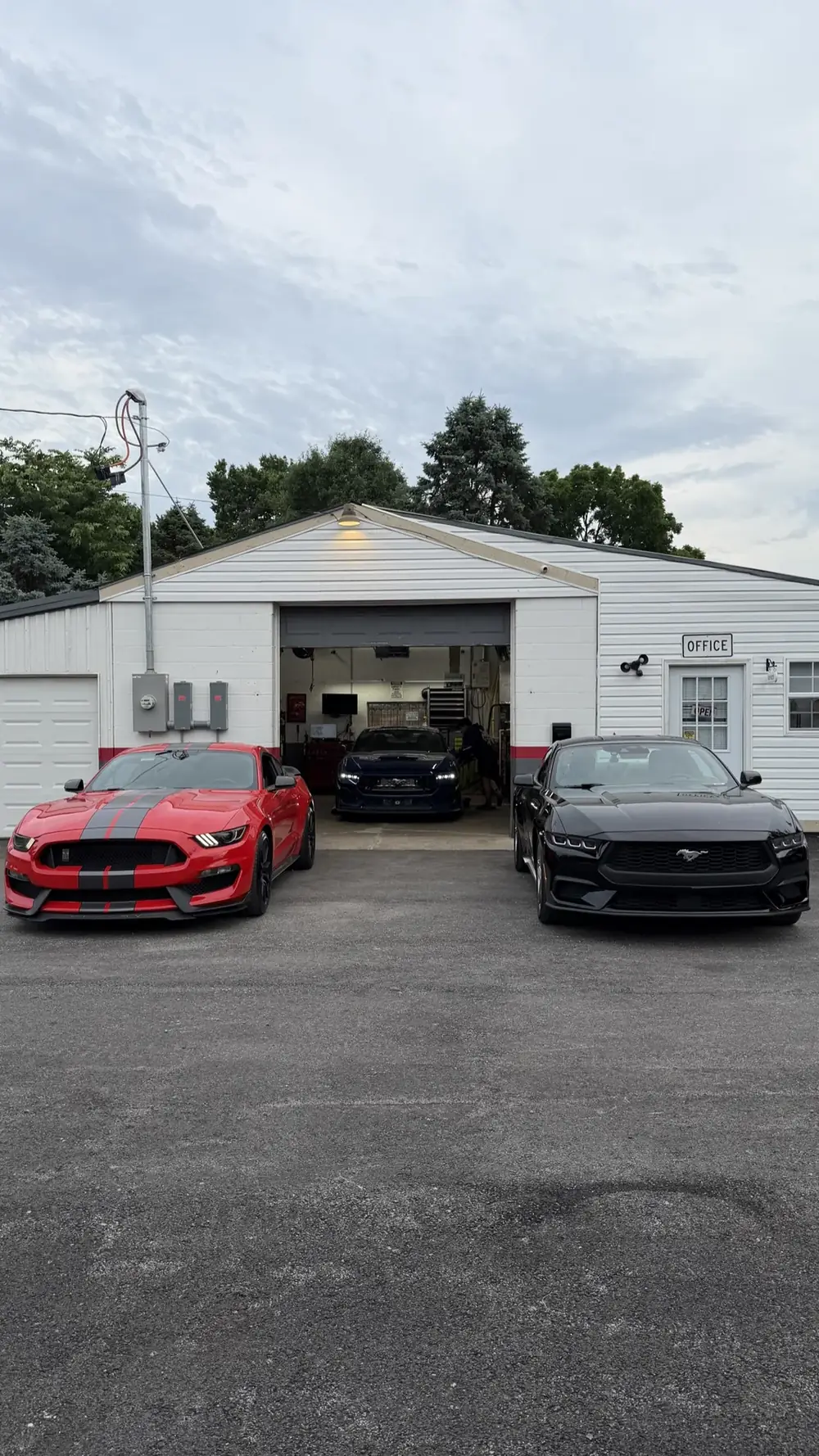 Performance Mustangs parked outside Dave's Mechanic Shop