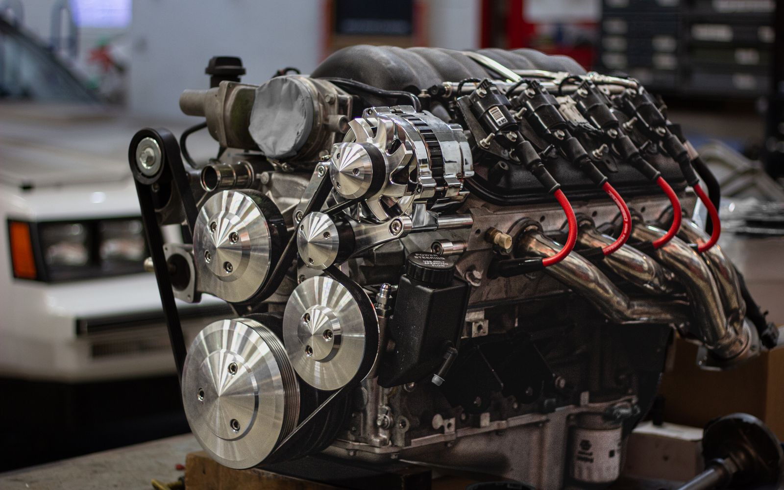 Complete automotive engine assembly prepared for repair in a workshop