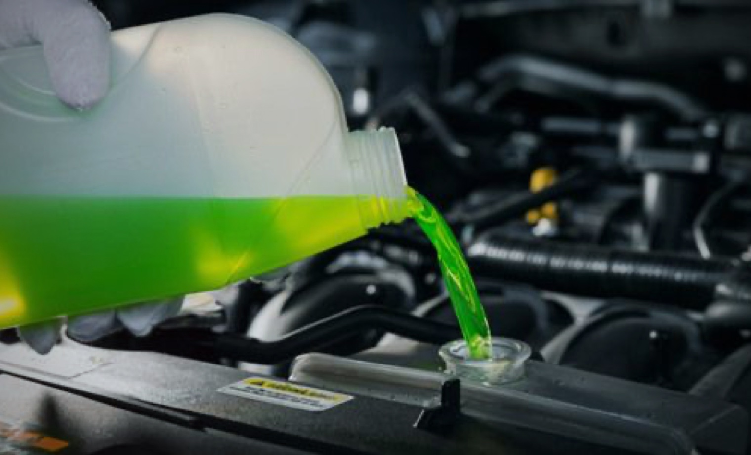 Bright green coolant being added to an automotive cooling system