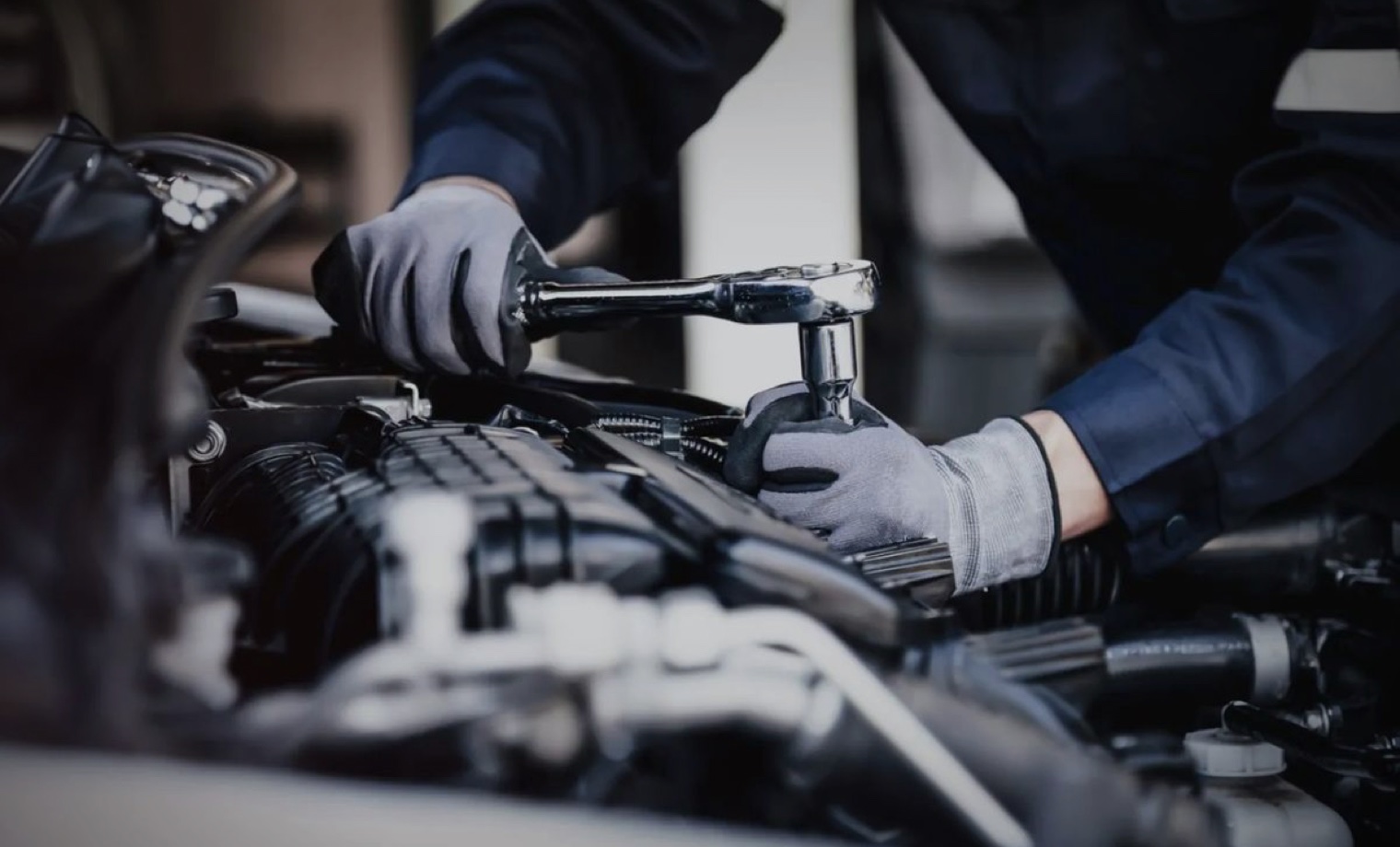 Automotive technician completing a general engine-bay repair