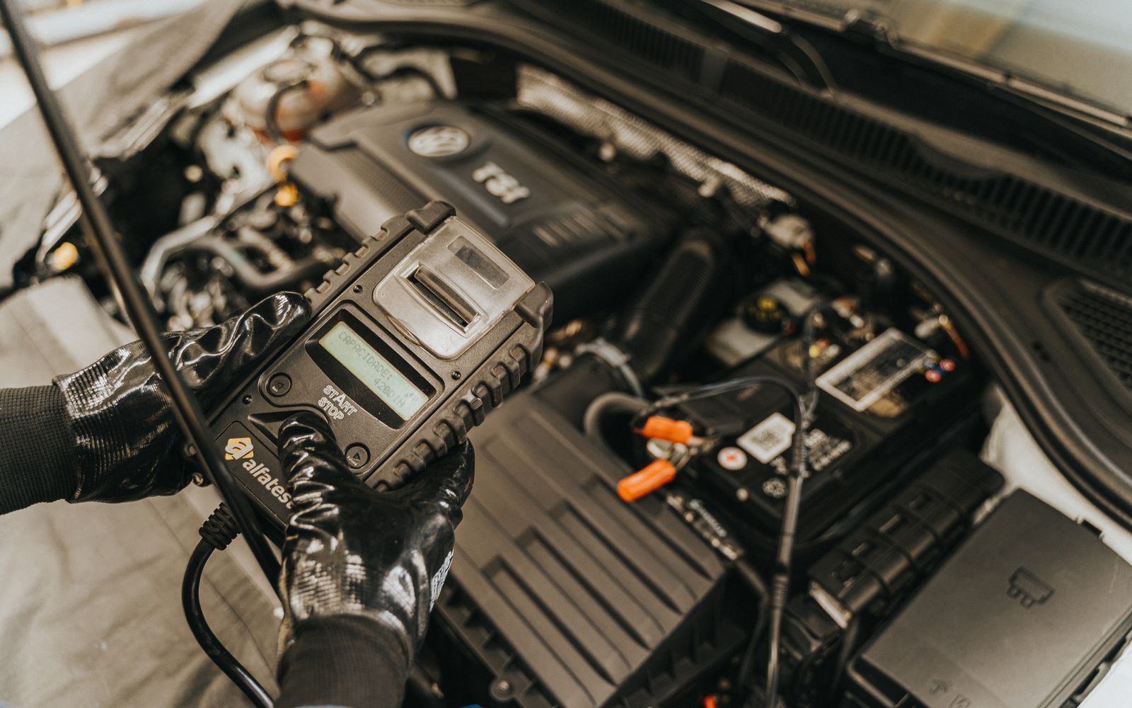 Technician testing an engine ignition and electrical system