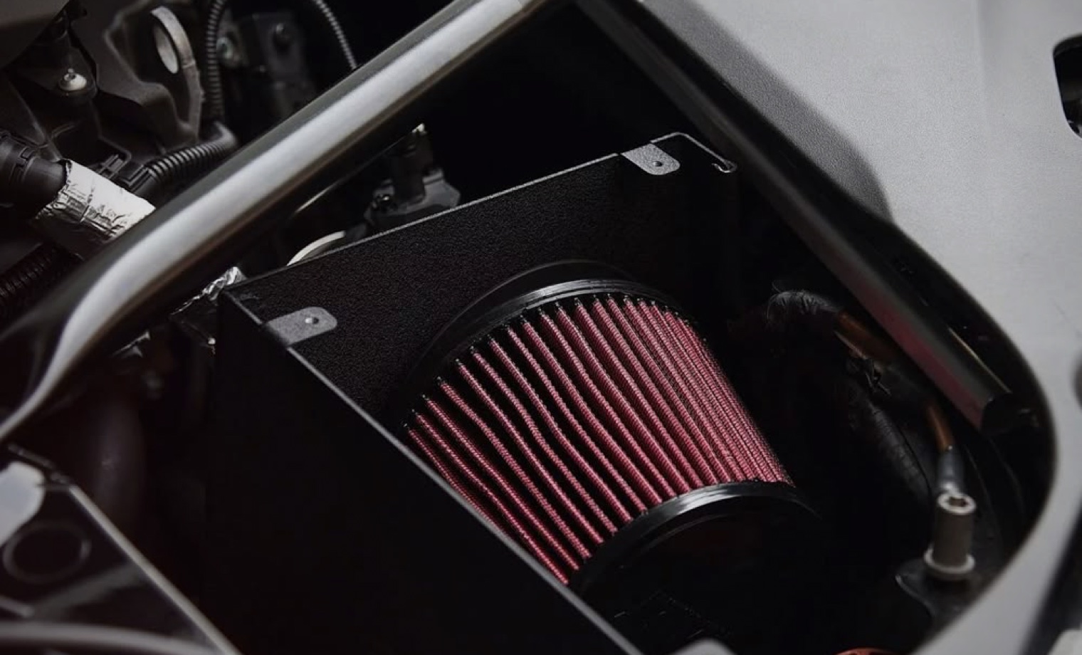 High-flow air intake filter installed inside an engine bay