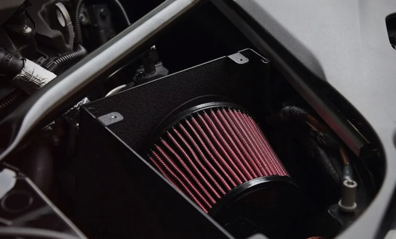 High-flow air intake filter installed inside an engine bay