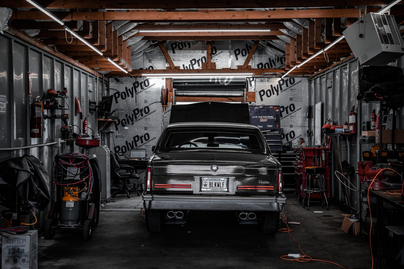 A customer's Cadillac in the service bay at Dave's Mechanic Shop